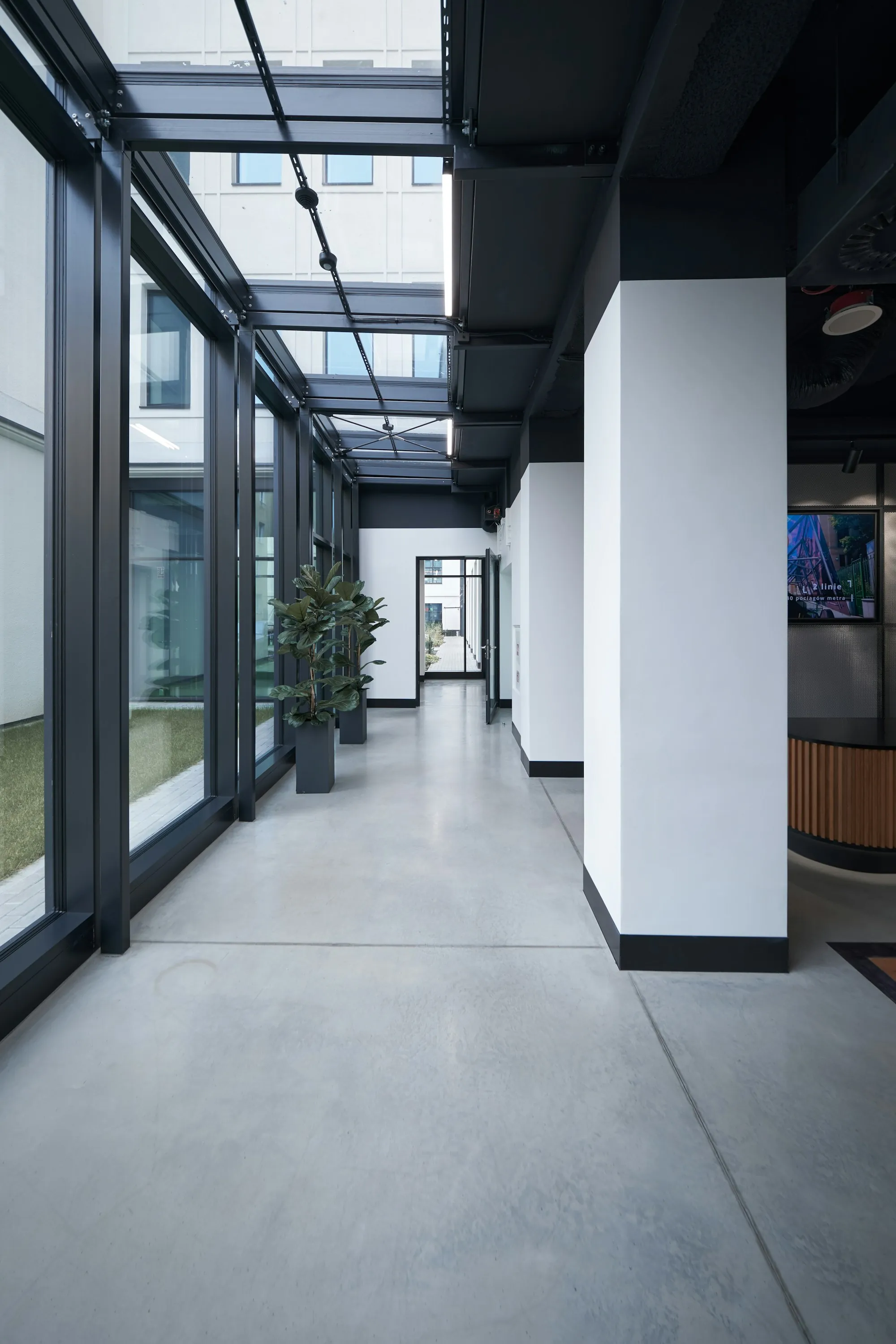 Bright hallway with polished concrete and glass walls